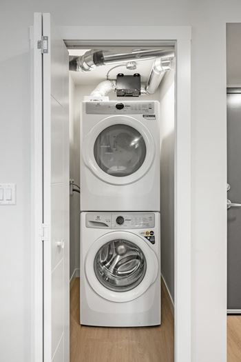 A white washing machine and dryer in a small laundry room.